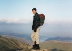 Image of man standing on a windswept mountain top